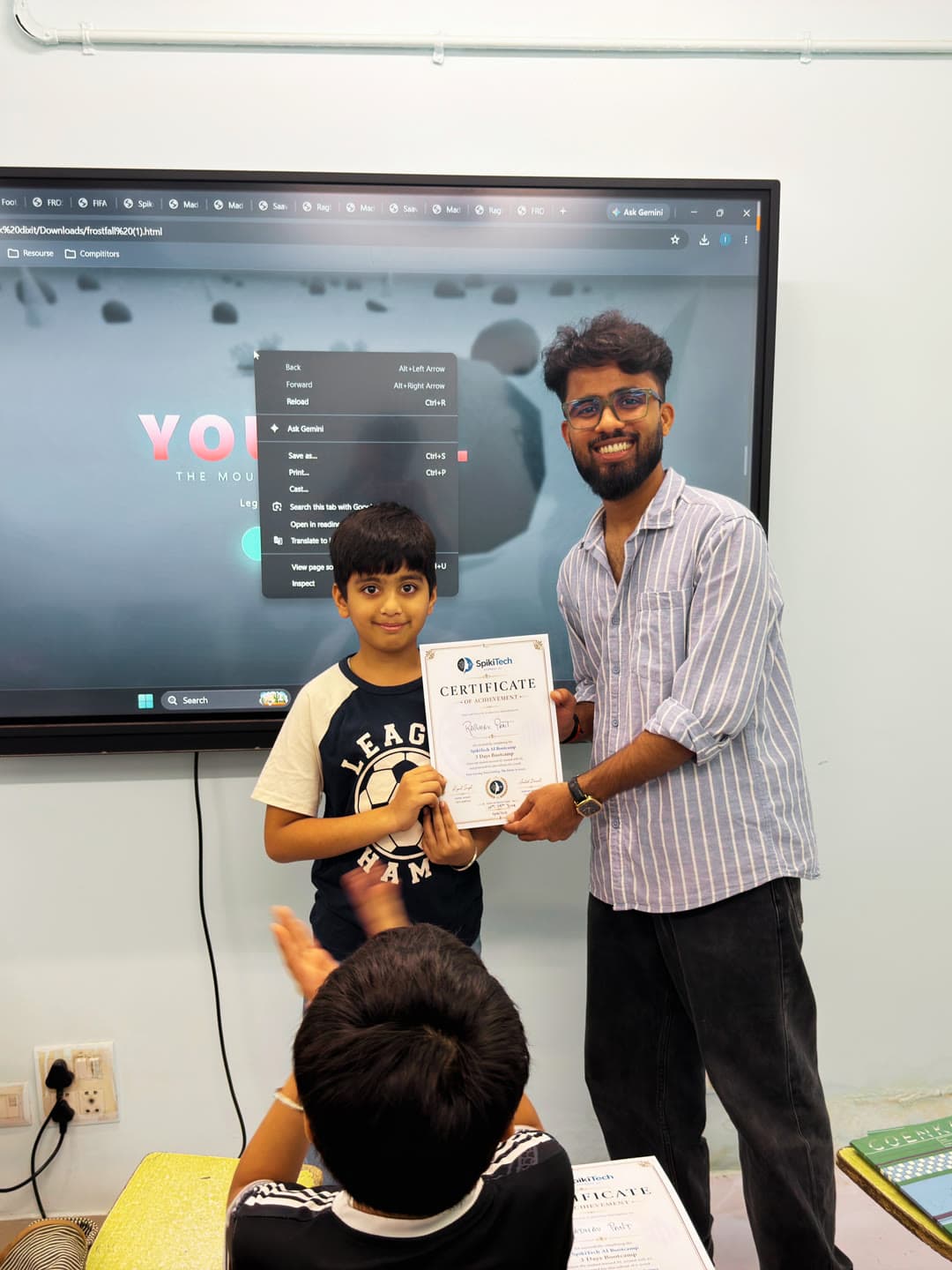 Student proudly holding their SpikiTech certificate.