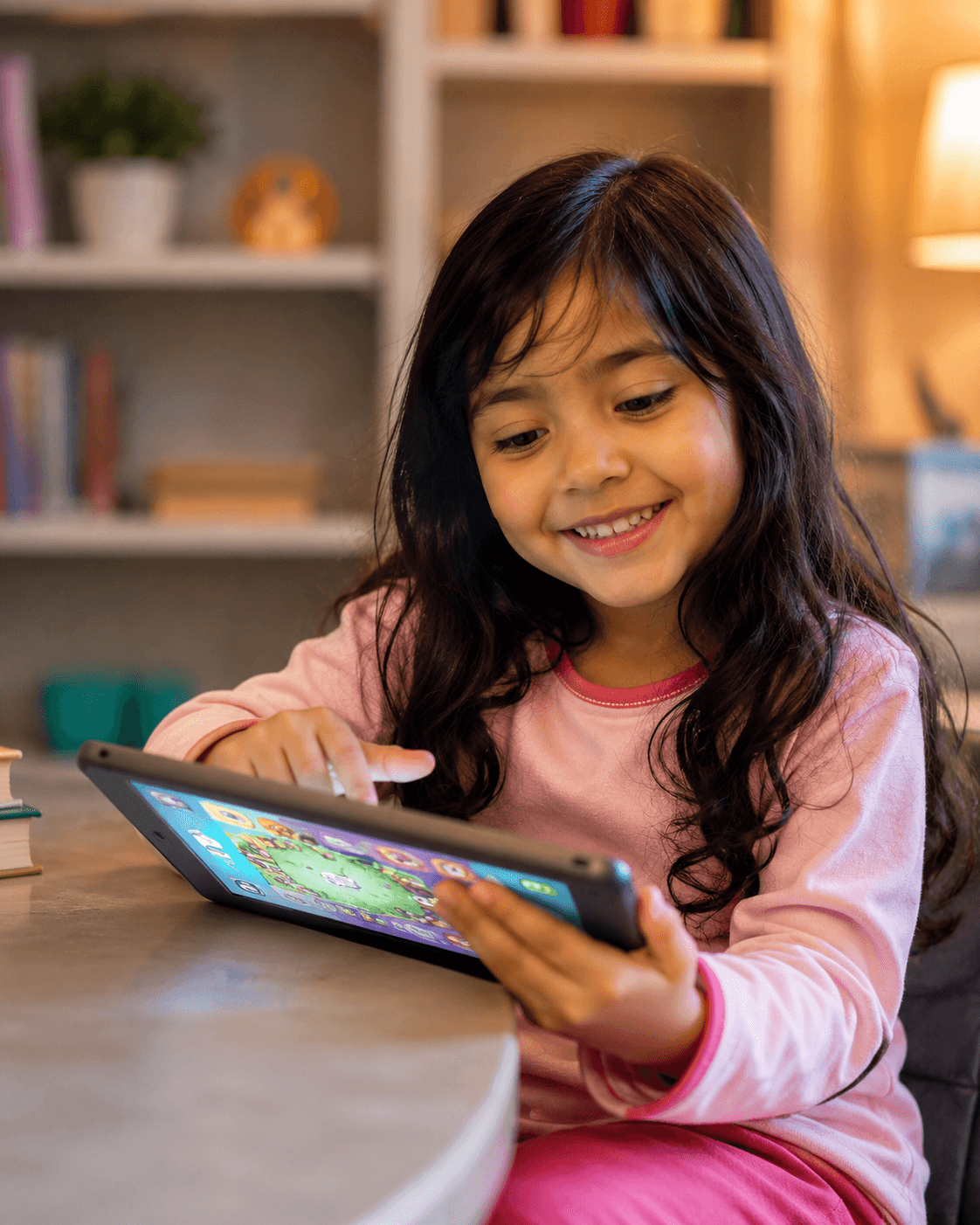 A smiling young girl enjoying a fun learning activity on a tablet